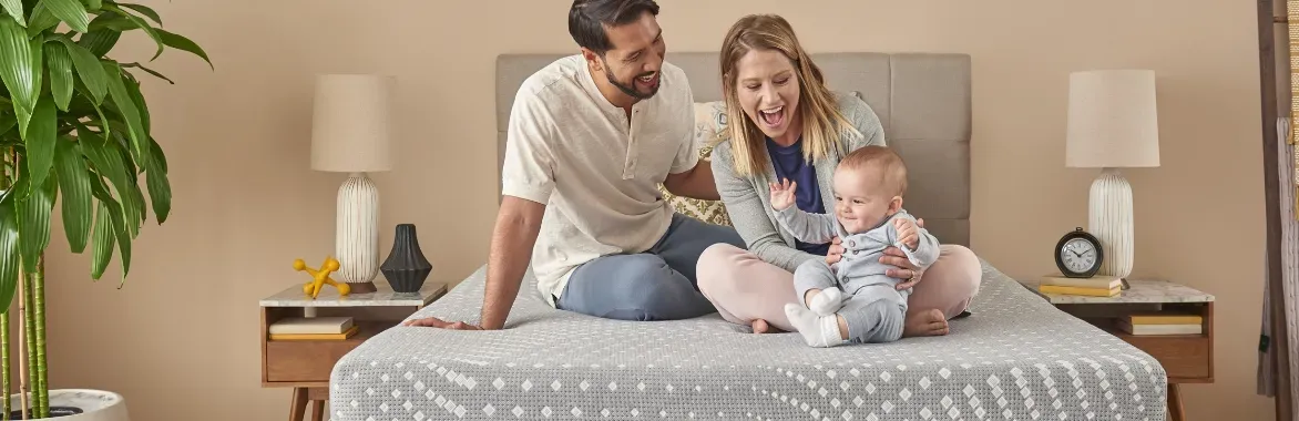 family sitting on mattress